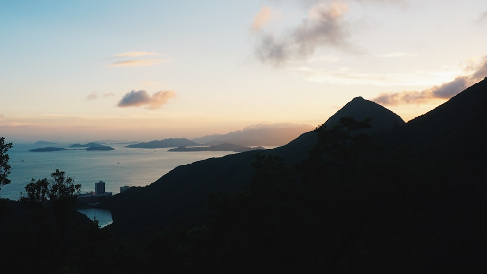 a view of a mountain with a body of water in the distance