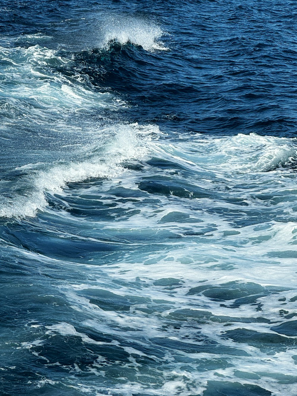 a person riding a surfboard on a wave in the ocean