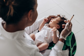 a woman holding a baby in her arms