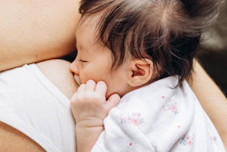 a close up of a person holding a baby