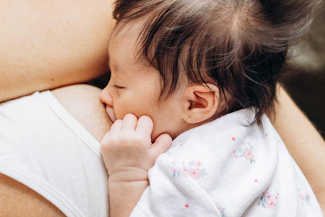 a close up of a person holding a baby