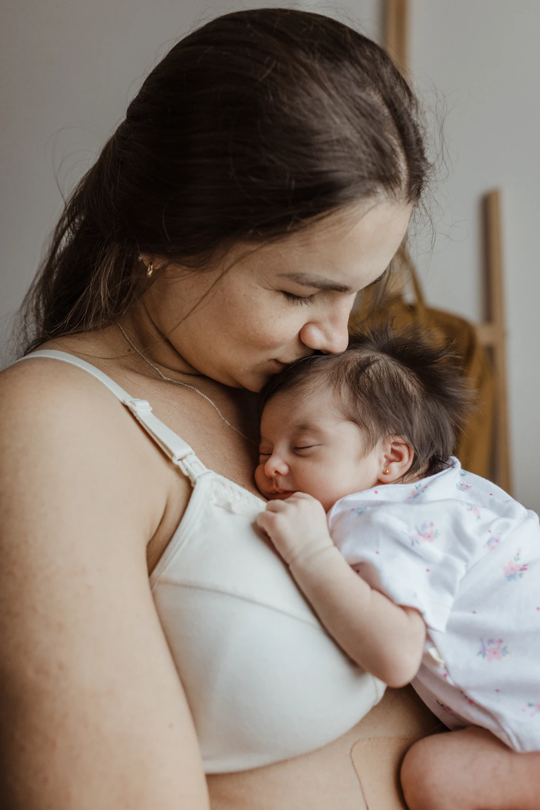 Parent holding a sleeping newborn close