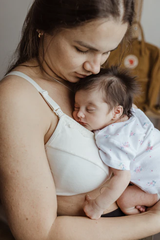 a woman holding a baby in her arms