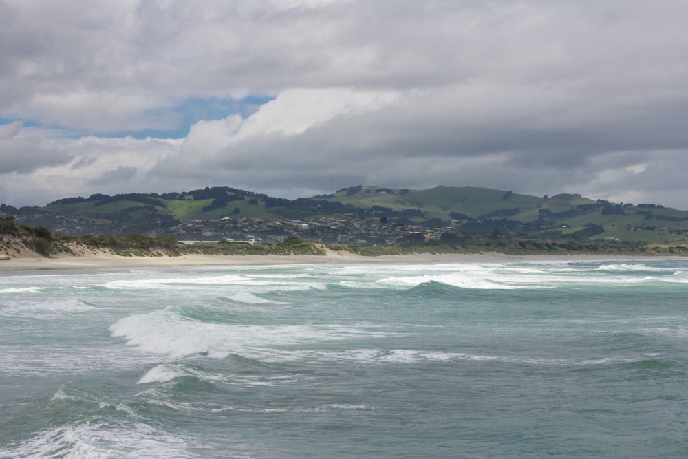 a view of a beach with waves coming in to shore