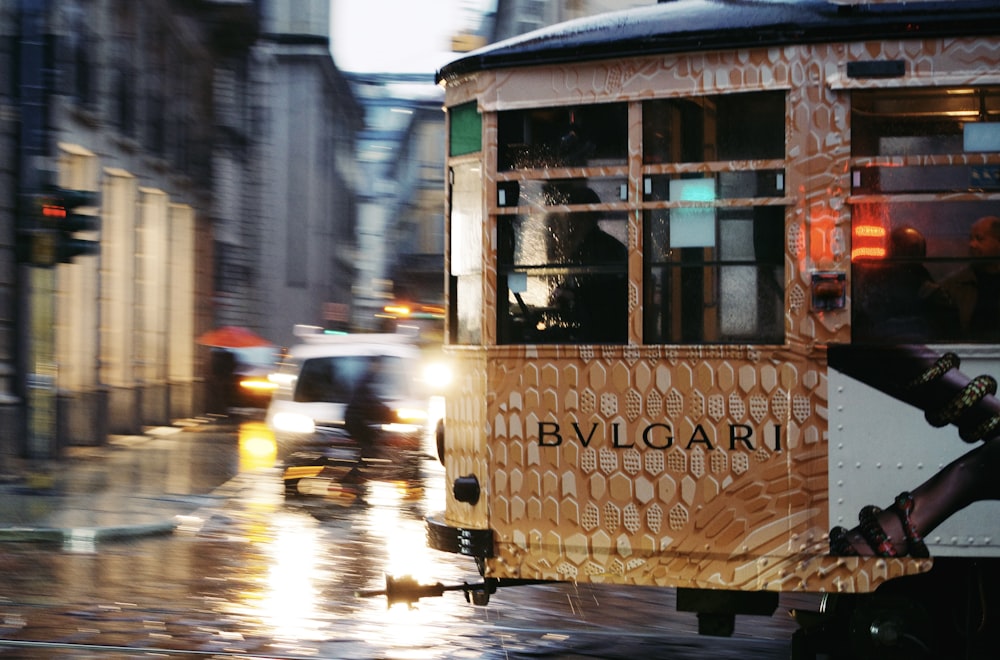a trolley car on a city street in the rain