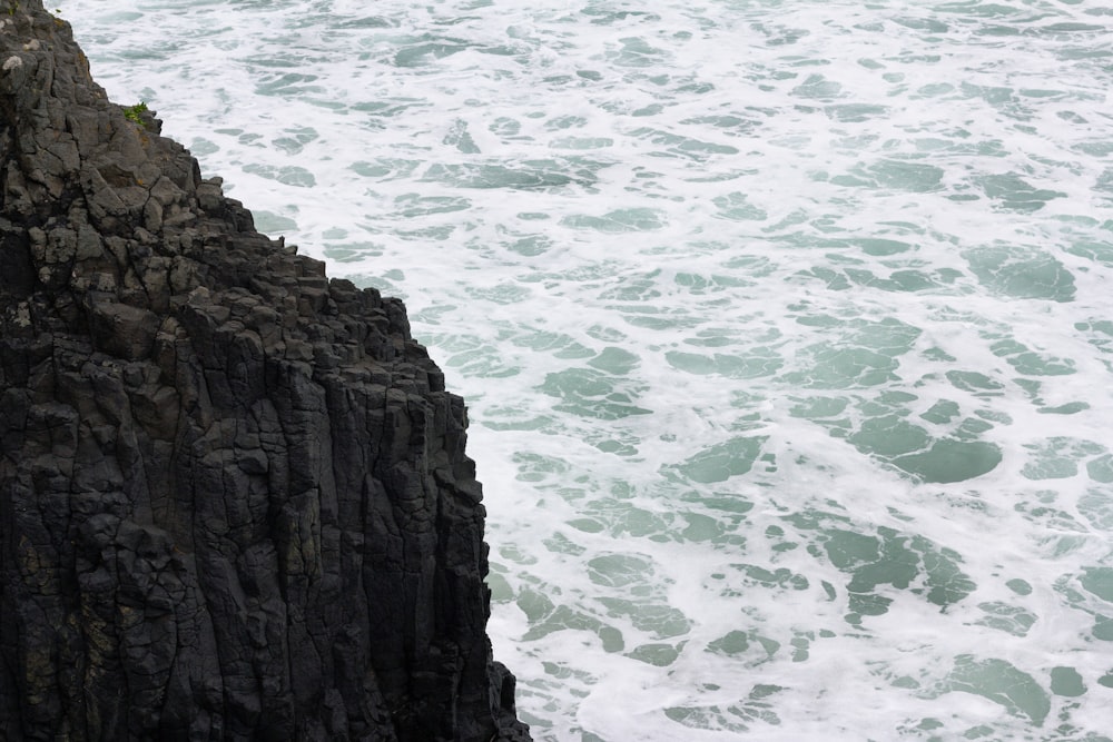 a person standing on a cliff overlooking the ocean