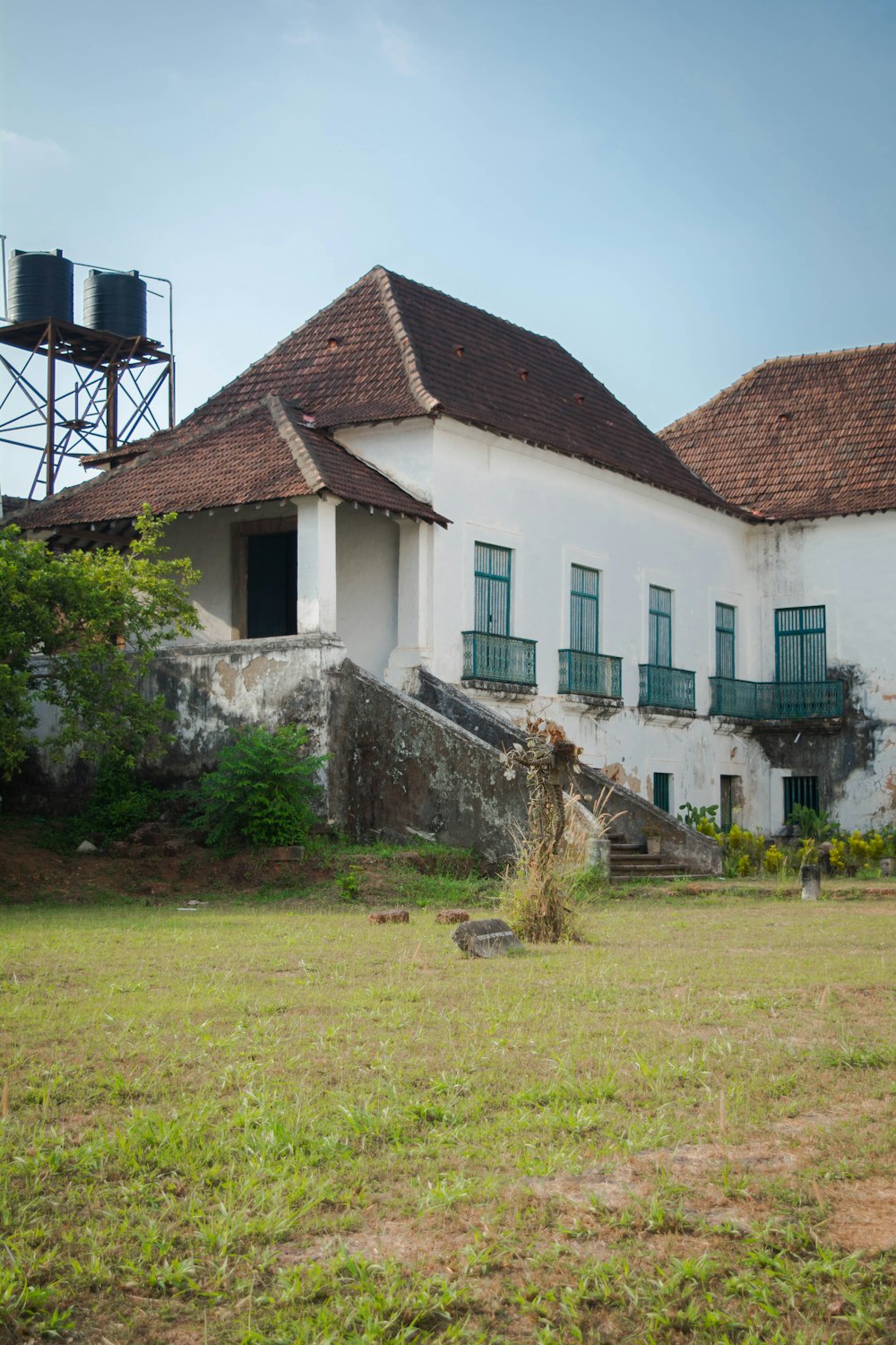 an old house with a water tower in the background