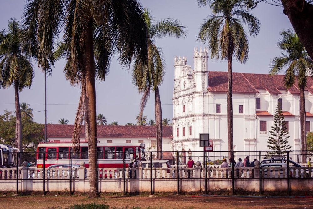 a large white building with a clock tower in the background