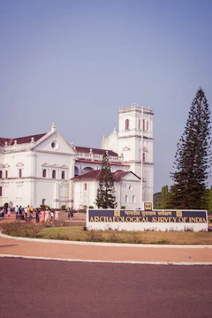 A group of people listening intently to a guide in front of a colonial-era building in Chennai.