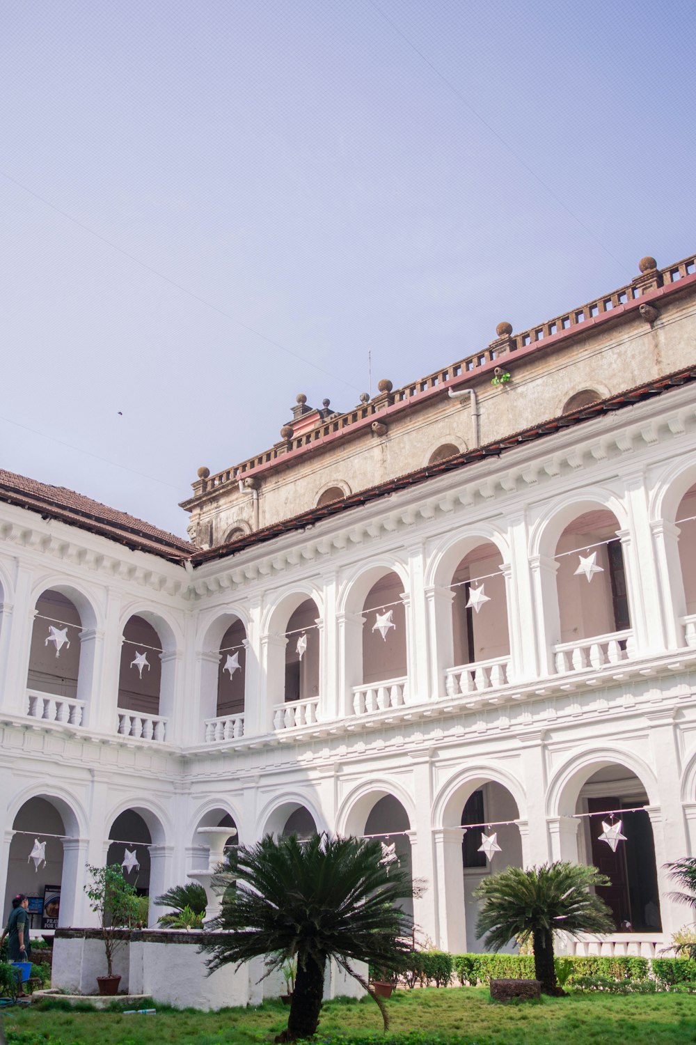 a large white building with arches and stars on it