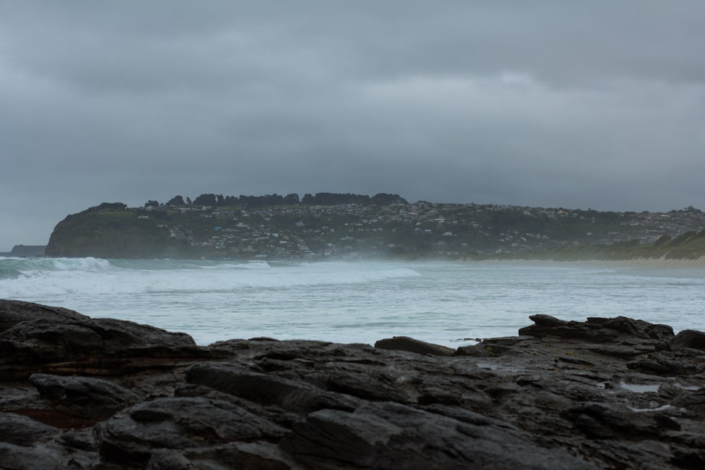 a large body of water near a rocky shore