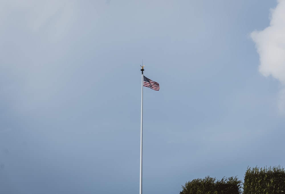 an american flag is flying high in the sky