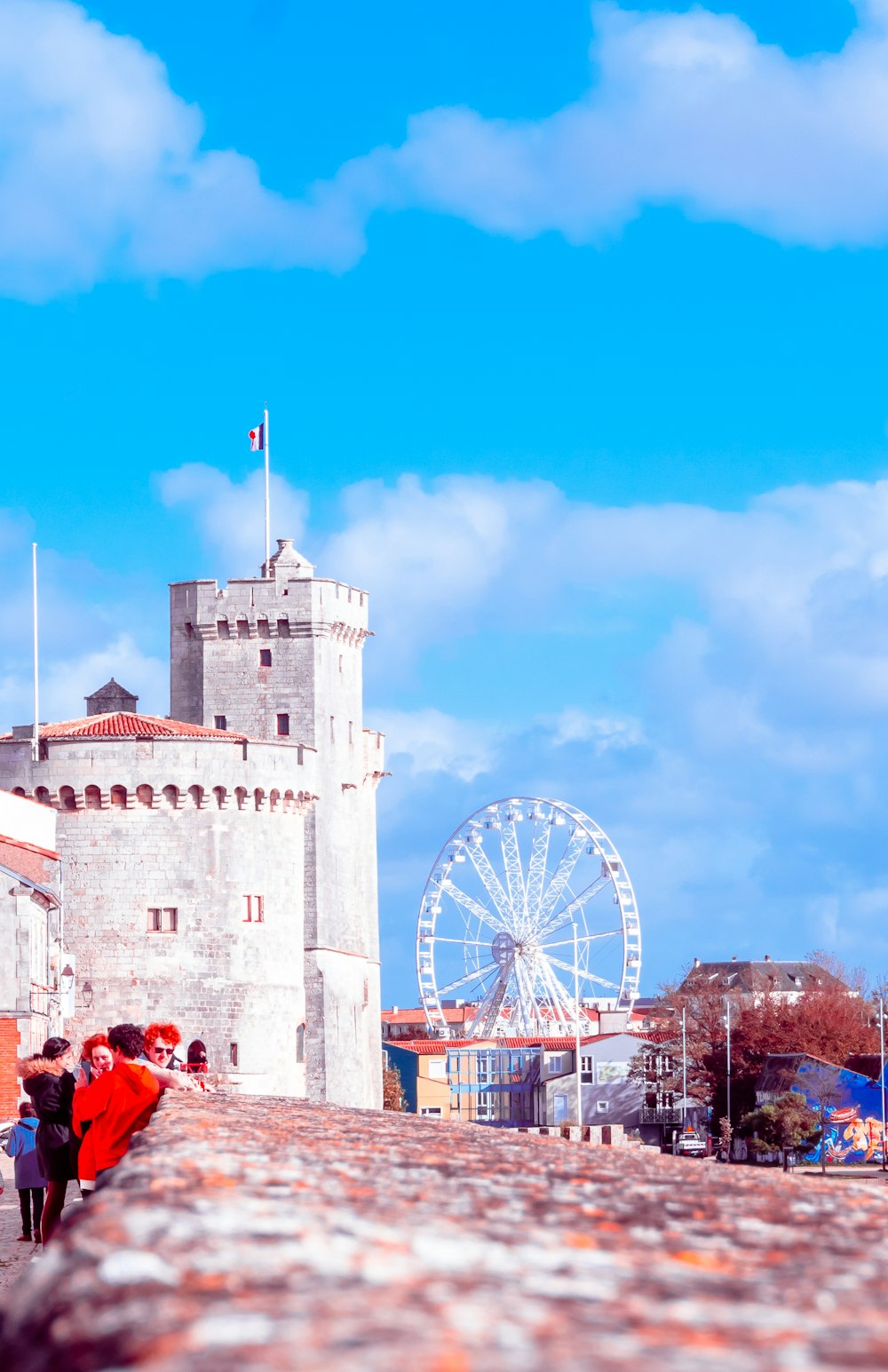 a castle with a ferris wheel in the background