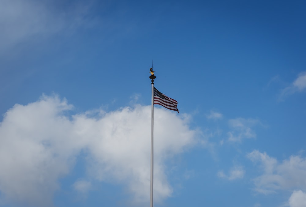 an american flag is flying high in the sky