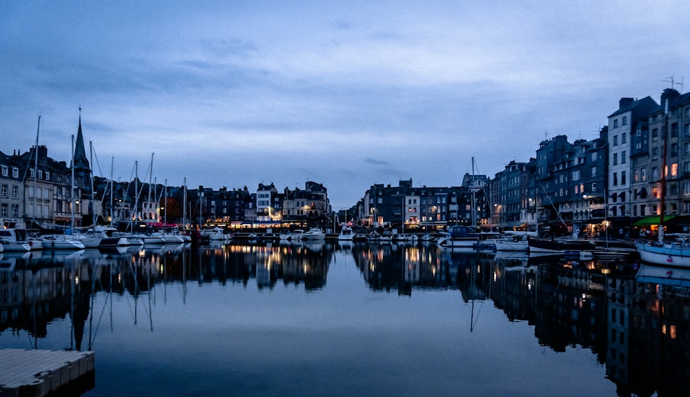 a harbor filled with lots of boats under a cloudy sky