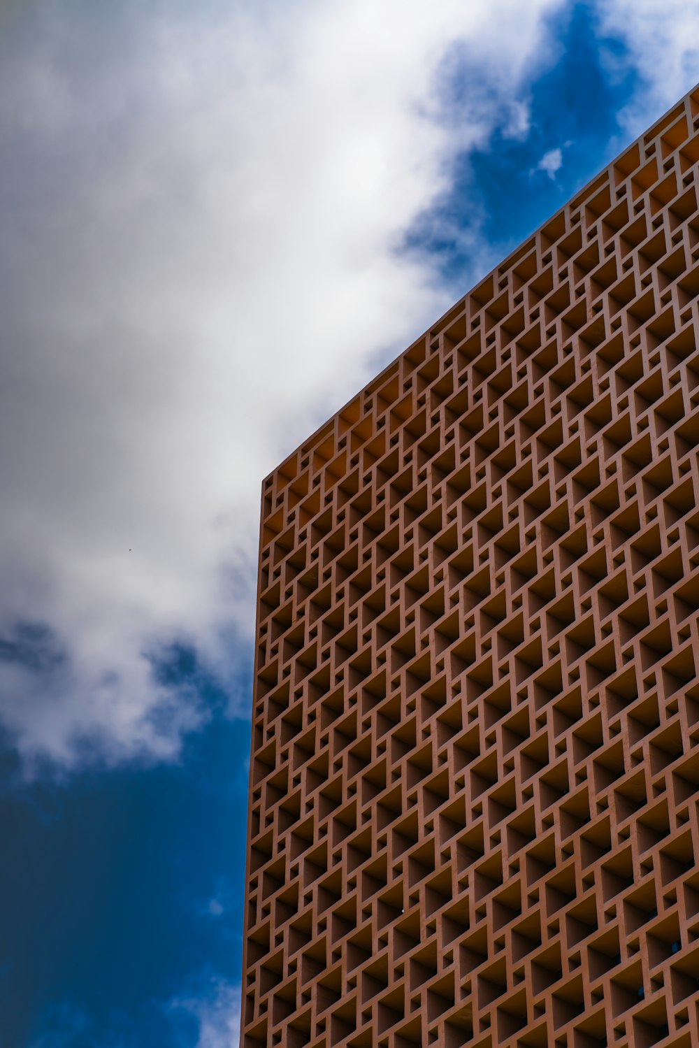 a tall brick building with a blue sky in the background