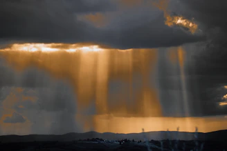 the sun is shining through the clouds in the sky