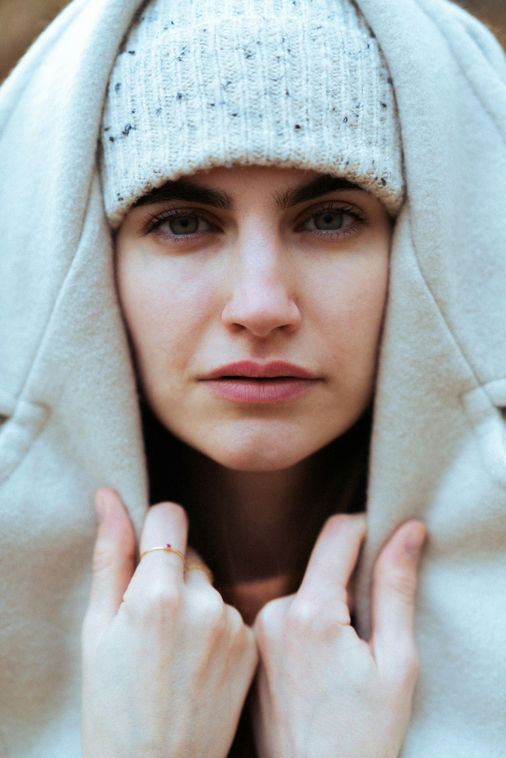 a woman wearing a white coat and a ring