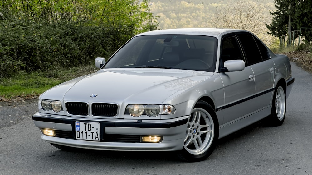 a silver car parked on the side of a road