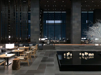 a room with tables, chairs, and candles