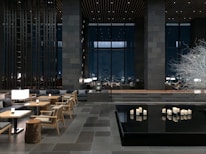 a room with tables, chairs, and candles