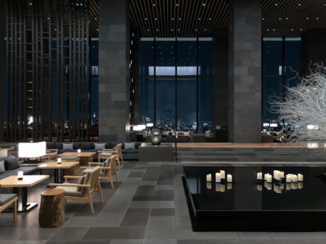 a room with tables, chairs, and candles