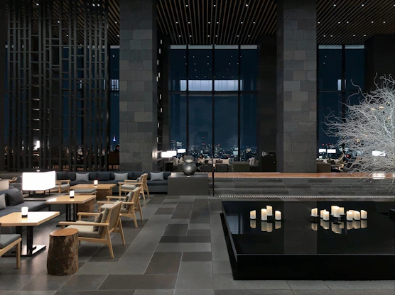 a room with tables, chairs, and candles