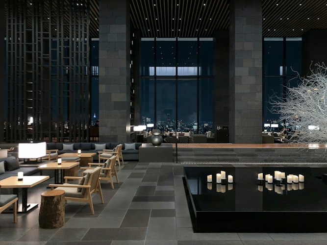 A hotel concierge desk with a staff member using a digital tablet to assist a guest