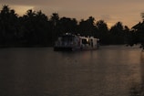 A serene Nile river cruise boat gliding past palm-lined banks at dawn.