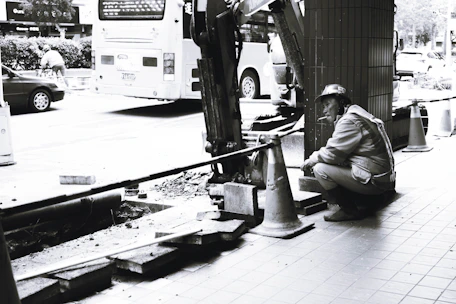A certified collector conducting an on-site drug test at a busy construction site.