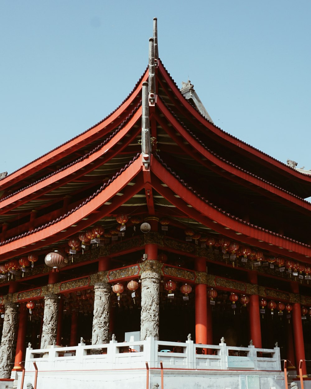 a tall red building with a sky background