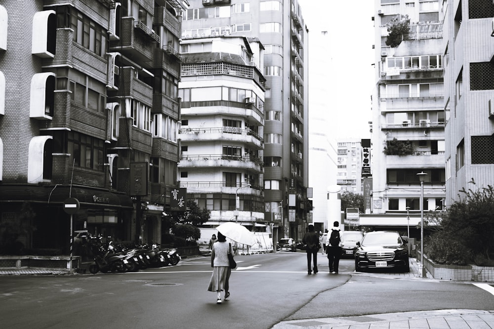 a man riding a skateboard down a street next to tall buildings