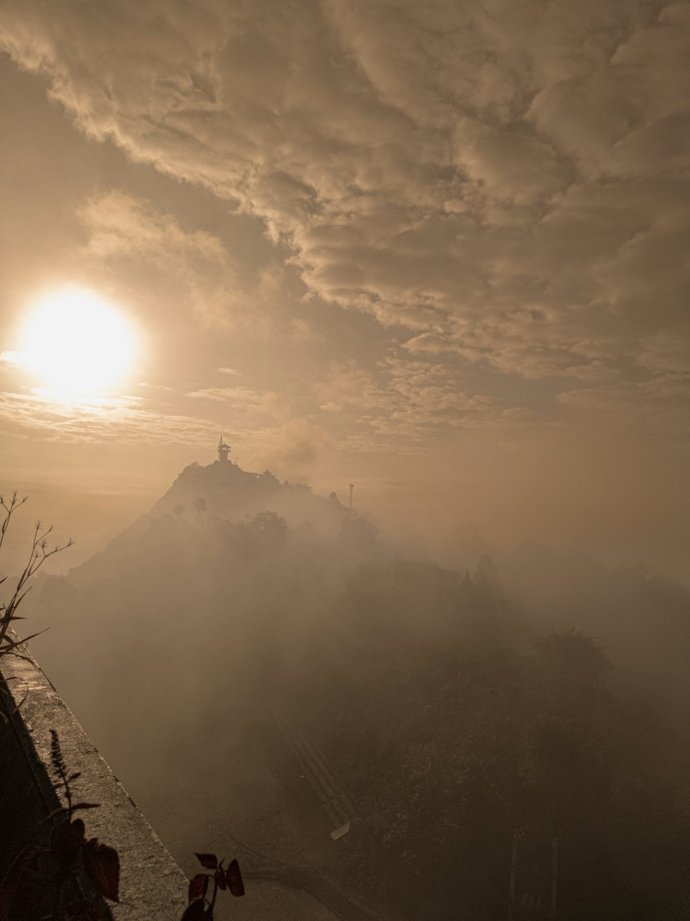 the sun is setting over a mountain range