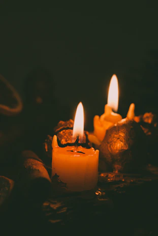 Candles lit softly in a dim room, creating an intimate atmosphere.