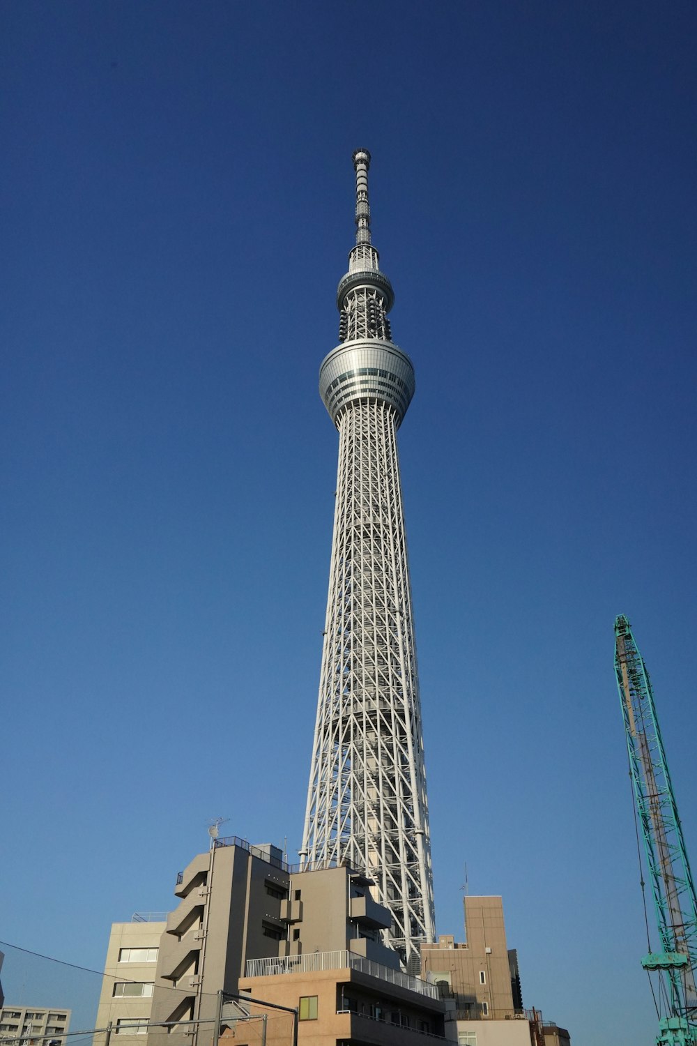 a very tall building with a very tall tower in the background