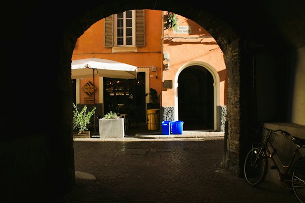 A bike is parked in front of a building — Parma, Italy