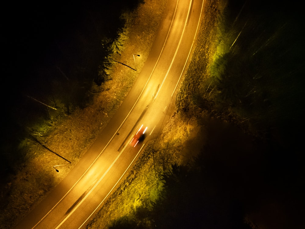 a car driving down a road at night