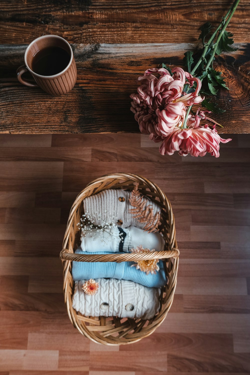 a basket filled with socks next to a cup of coffee