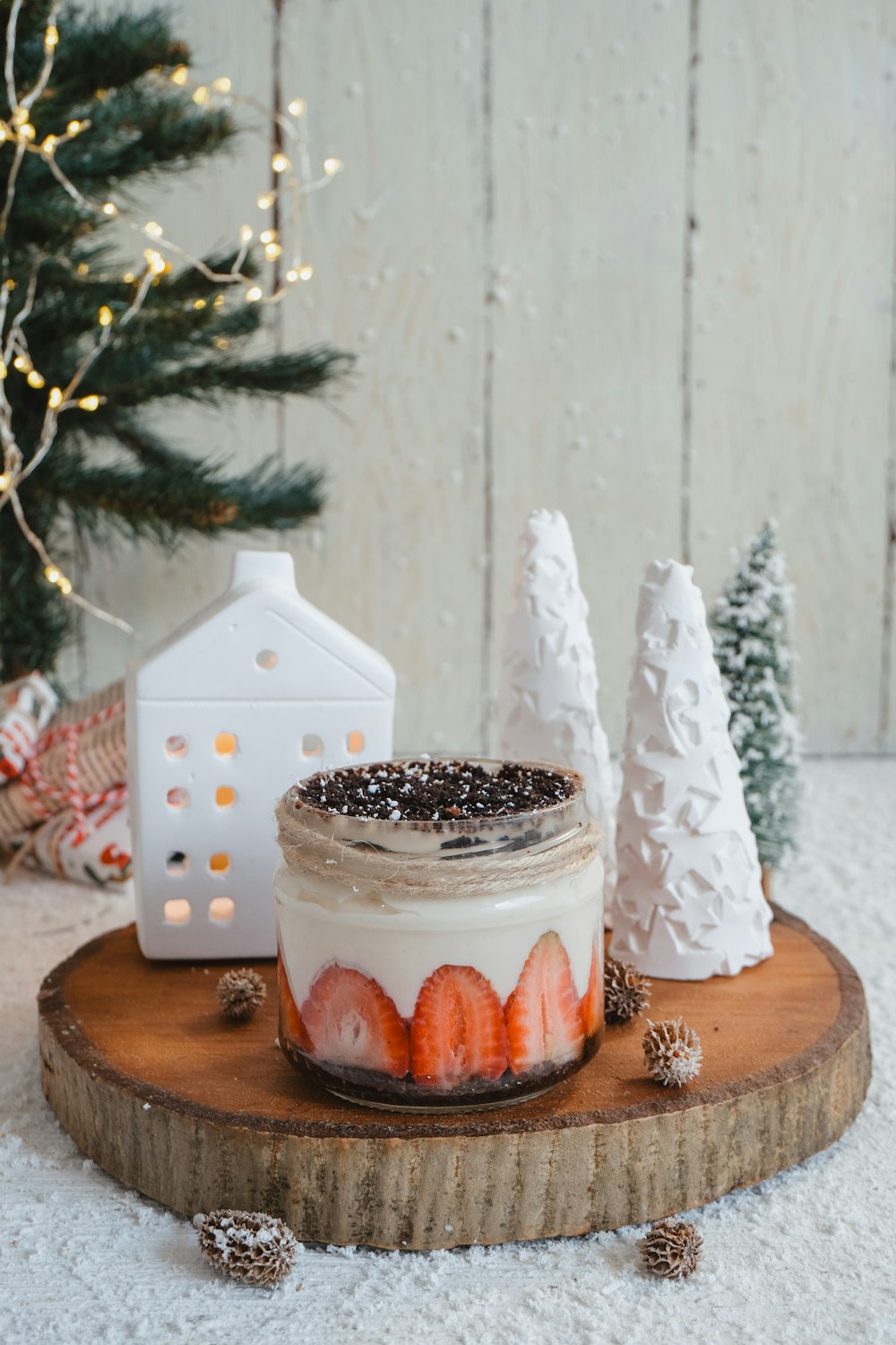 a mason jar filled with strawberries sitting on top of a wooden board