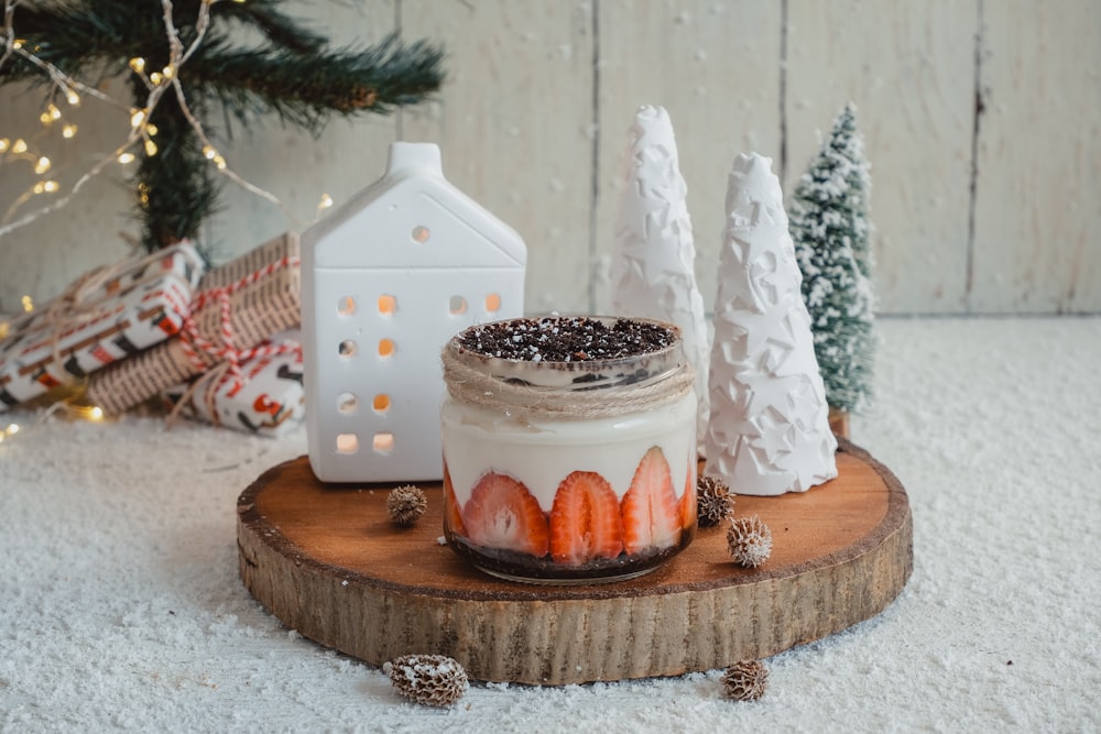 a dessert with strawberries and whipped cream on a wooden board