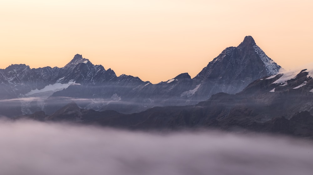 a view of a mountain range covered in fog