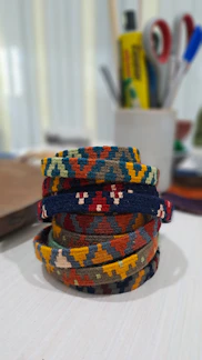 Close-up of colorful handmade beaded bracelets arranged on a rustic wooden table.