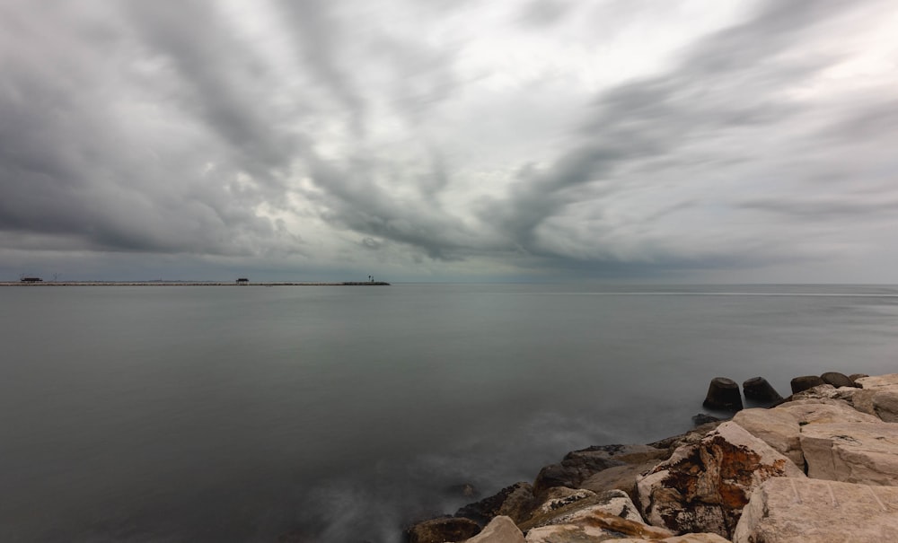 a large body of water under a cloudy sky