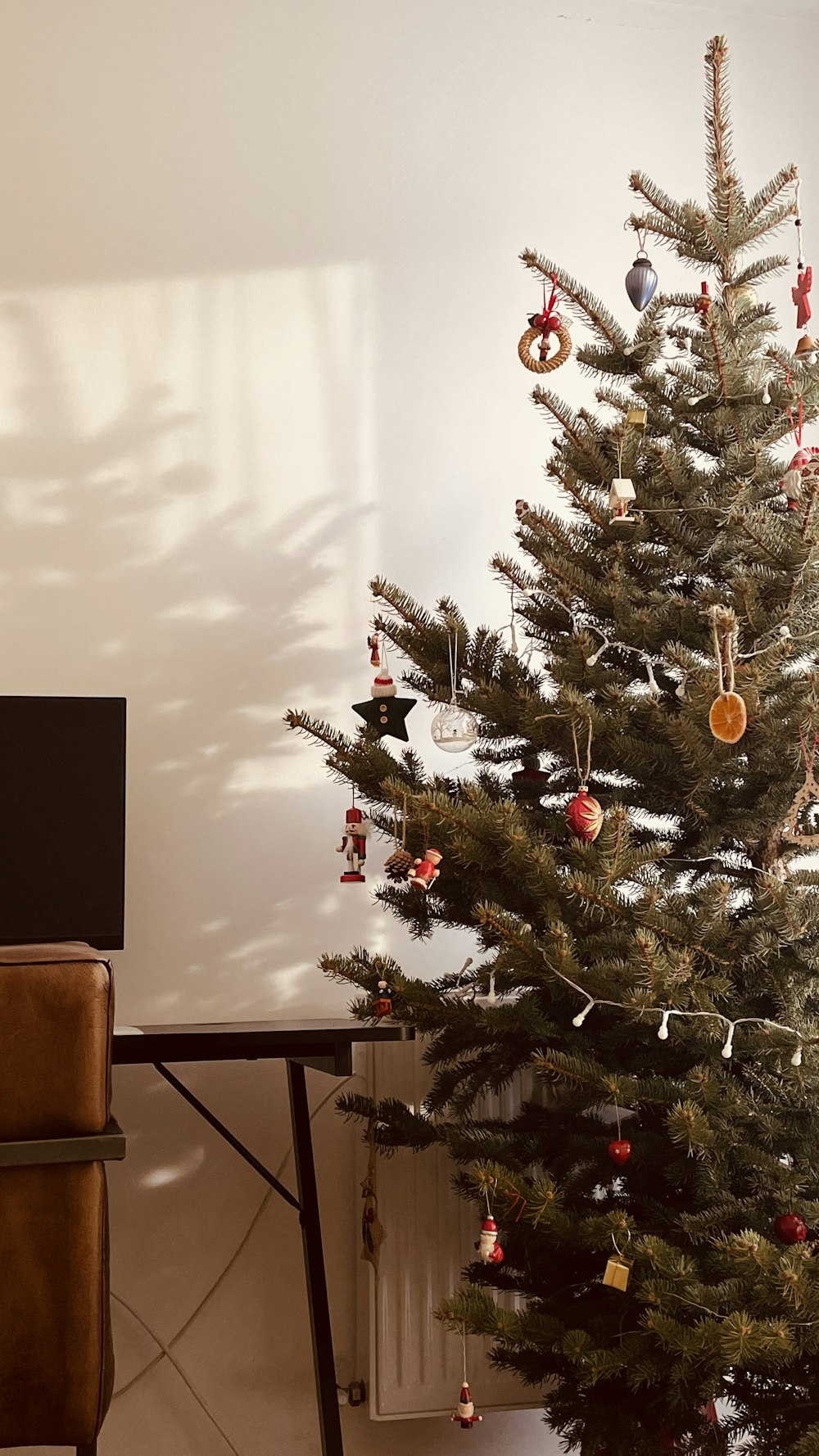 a small christmas tree in a corner of a room