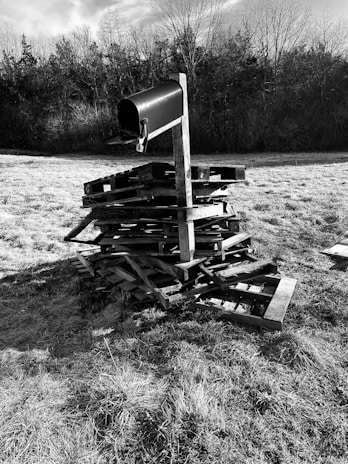 Close-up of a freshly installed black metal mailbox on a sturdy pressure-treated 4x4 post in a sunny Ohio neighborhood.