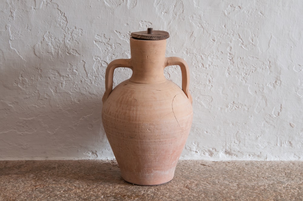 a large brown vase sitting on top of a table