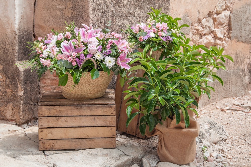 a basket of flowers sitting on a wooden crate