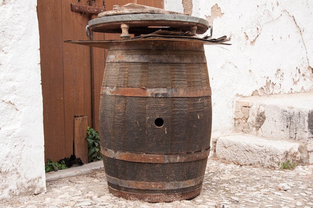 a wooden barrel sitting in front of a door