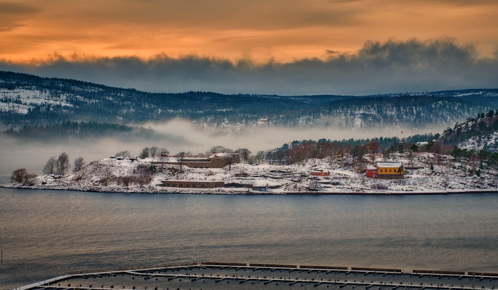 a large body of water surrounded by snow covered mountains