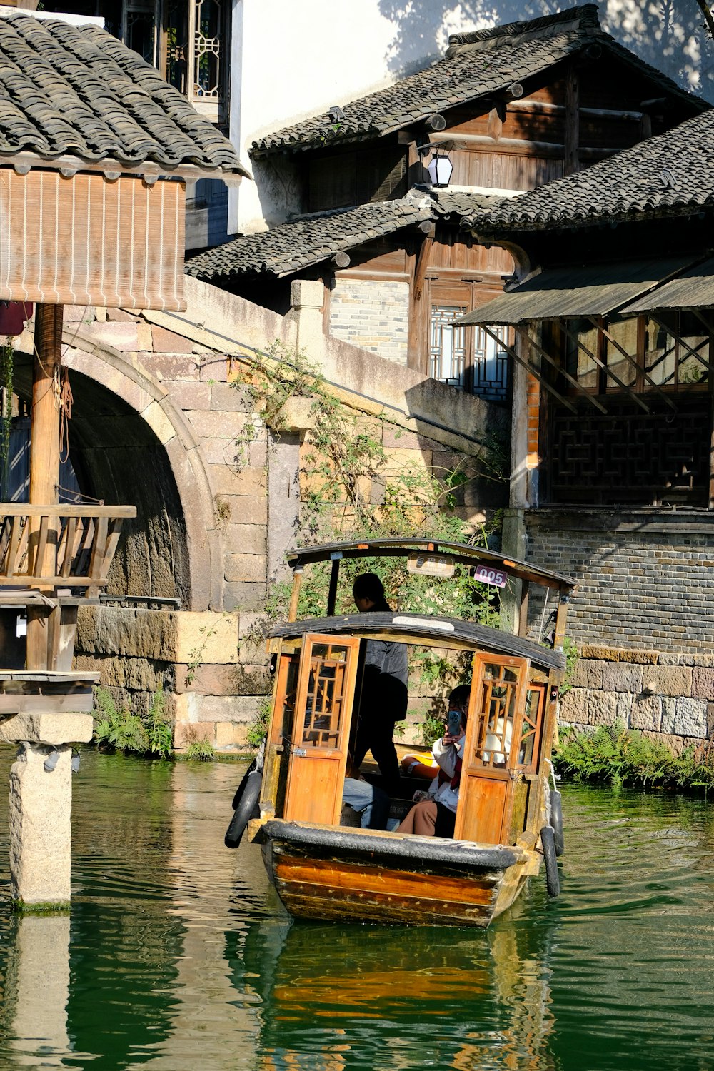 a boat floating on top of a river next to a building